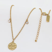 Load image into Gallery viewer, Gold necklace with a round pendant on a white background