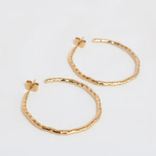 Load image into Gallery viewer, Gold hoop earrings on a light gray background