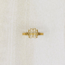 Load image into Gallery viewer, Gold lotus flower ring on a textured white background